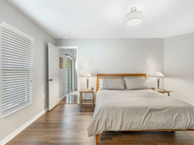 bedroom with dark wood-type flooring