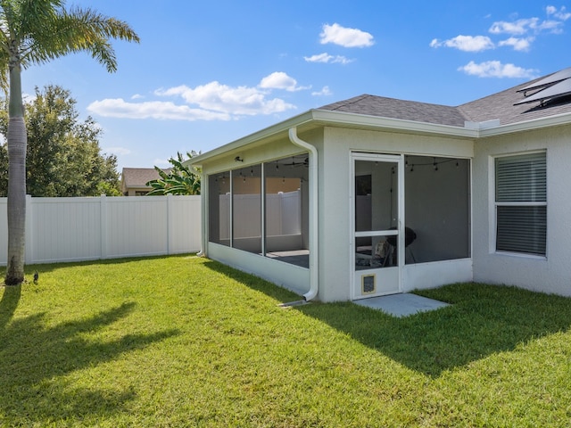 exterior space with a lawn and a sunroom