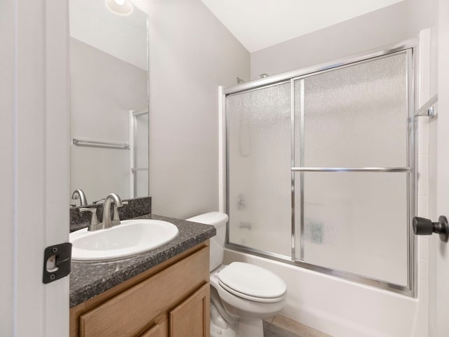 full bathroom with vanity, combined bath / shower with glass door, and toilet