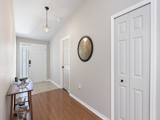 entryway featuring hardwood / wood-style floors and lofted ceiling