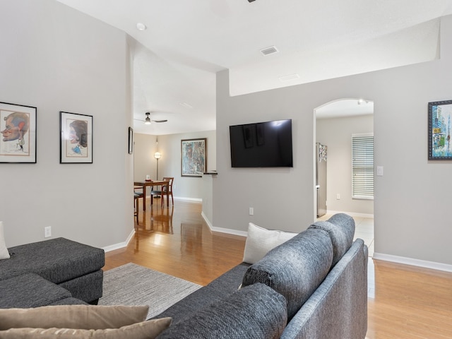 living room featuring light hardwood / wood-style flooring and ceiling fan