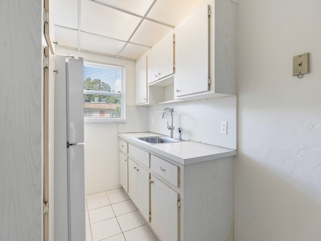 923 22nd Pl Unit 209, Vero Beach, FL 32960 - kitchen with white cabinetry, sink, white refrigerator, and light tile patterned floors