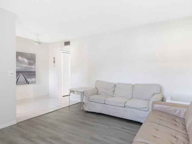 living room with ceiling fan and wood-type flooring