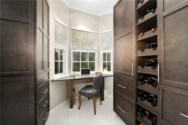 office area with crown molding, baseboards, and light tile patterned floors