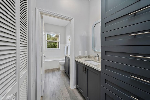 1440 Winding Oaks Cir W Unit A204, Vero Beach, FL 32963 - bathroom with vanity, wood finished floors, and a bath
