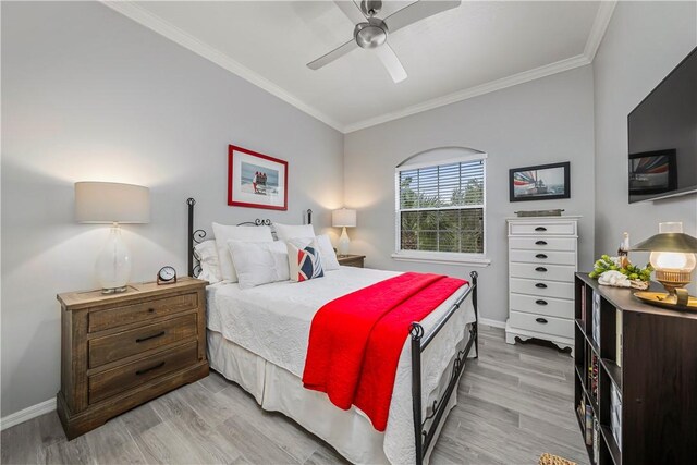 bedroom featuring baseboards, ornamental molding, and light wood-type flooring