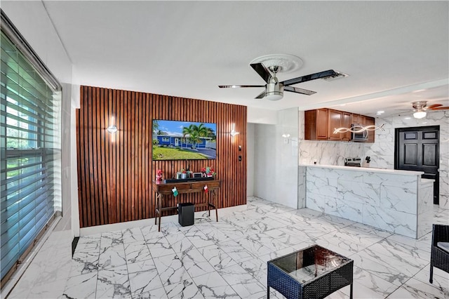 living room with wooden walls and ceiling fan