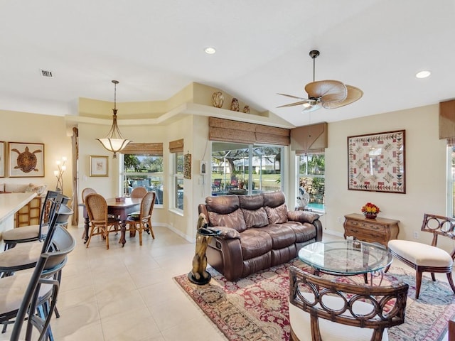 living room with lofted ceiling, a healthy amount of sunlight, light tile patterned floors, and ceiling fan