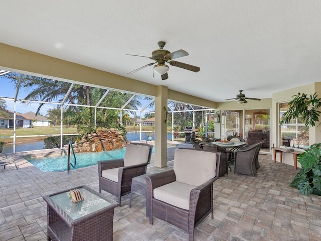 view of patio featuring ceiling fan and a lanai