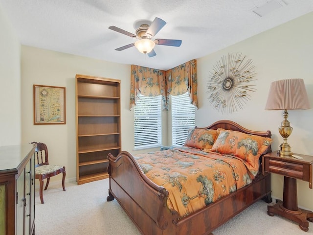 bedroom featuring ceiling fan and light carpet