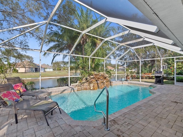 view of pool with a patio area, grilling area, a water view, and glass enclosure