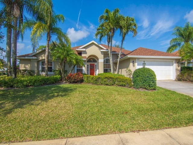 ranch-style house featuring a garage and a front yard