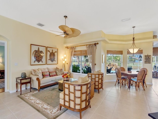 living room with ceiling fan and light tile patterned floors