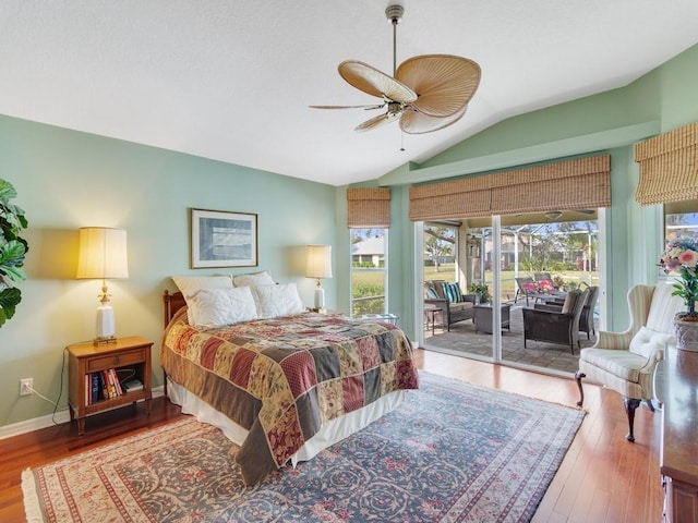 bedroom featuring vaulted ceiling, hardwood / wood-style floors, access to exterior, and ceiling fan