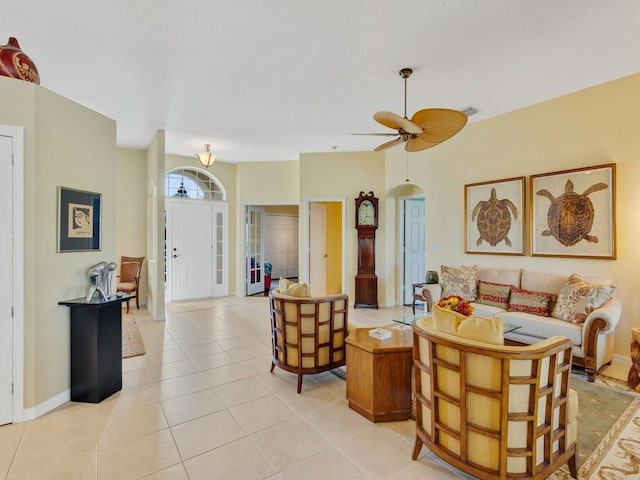 tiled living room with ceiling fan