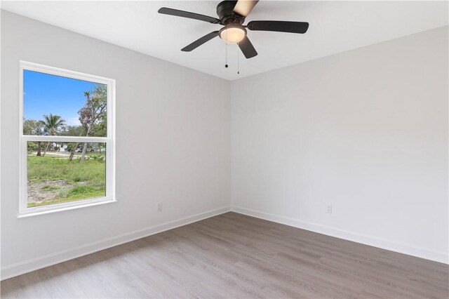 unfurnished room featuring ceiling fan and hardwood / wood-style floors