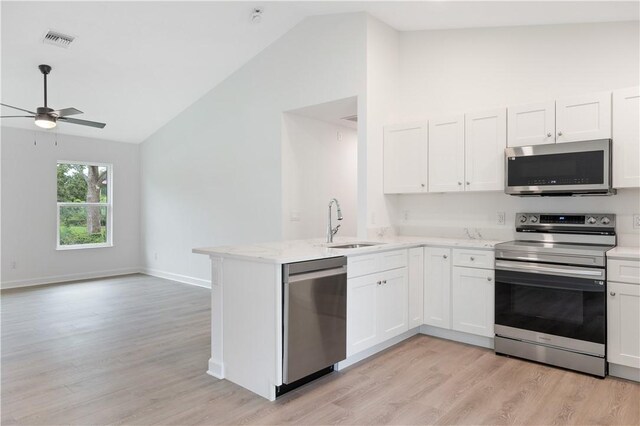 kitchen featuring sink, light hardwood / wood-style flooring, white cabinets, and appliances with stainless steel finishes