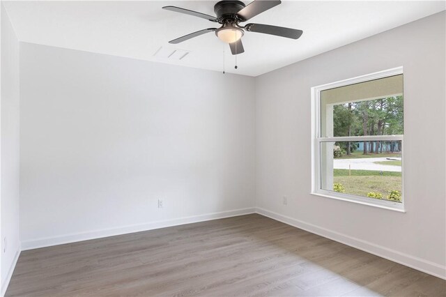 empty room featuring hardwood / wood-style flooring and ceiling fan