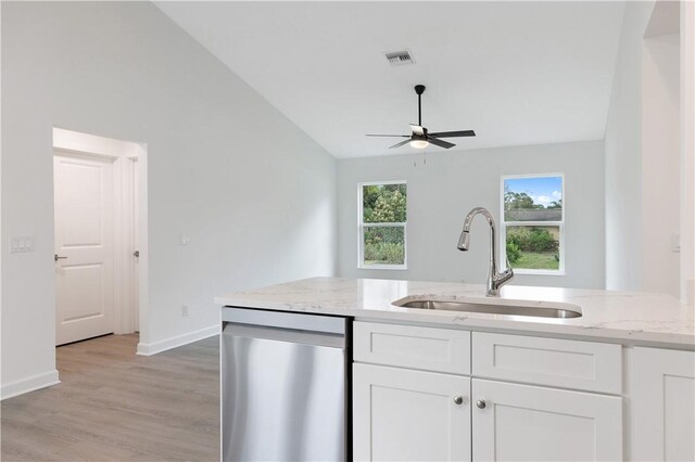 kitchen featuring dishwasher, white cabinets, lofted ceiling, and sink