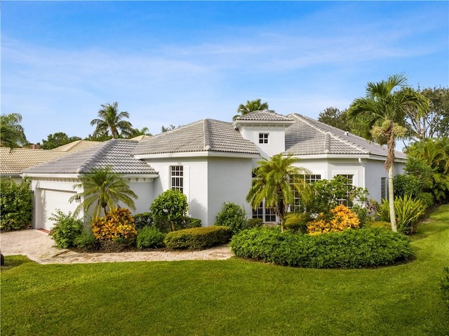 view of front of house with a garage and a front yard