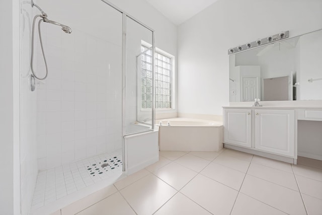 bathroom featuring tile patterned floors, vanity, and shower with separate bathtub