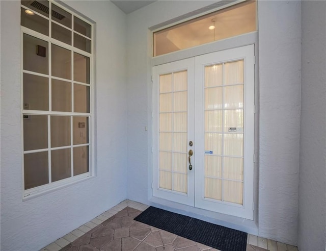 interior space with tile patterned flooring and french doors