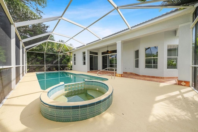 view of swimming pool featuring glass enclosure, an in ground hot tub, a patio area, and ceiling fan