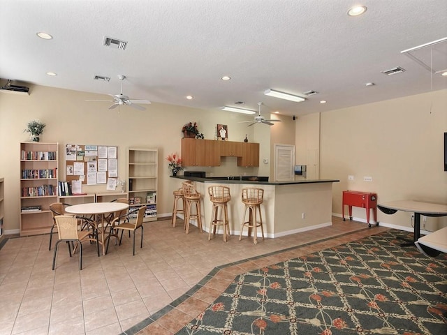 dining area with ceiling fan, attic access, light tile patterned floors, recessed lighting, and baseboards
