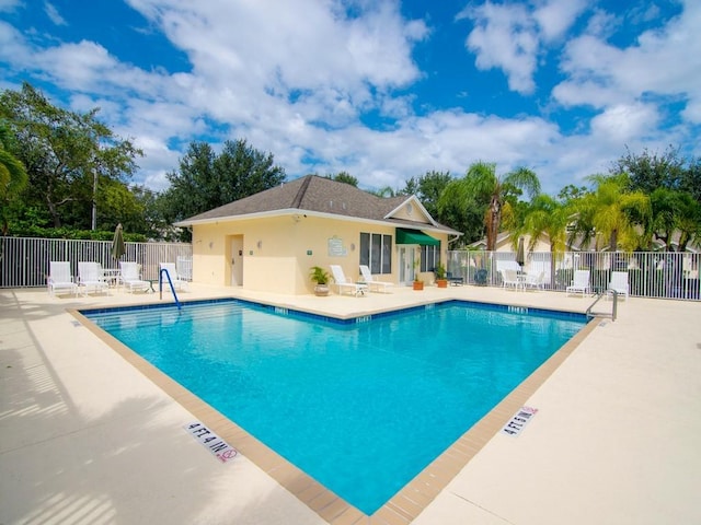 community pool featuring a patio area and fence