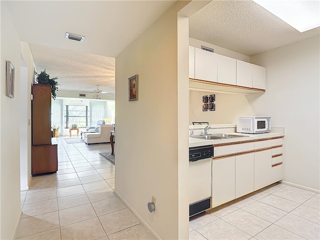 kitchen with ceiling fan, a sink, light countertops, white appliances, and light tile patterned flooring
