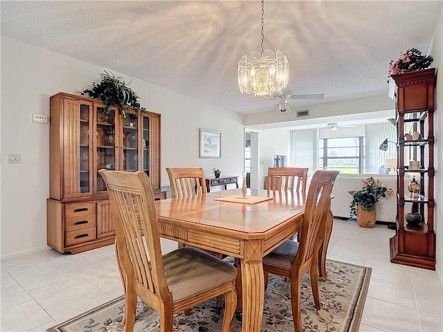 32 Plantation Dr Unit 102, Vero Beach, FL 32966 - dining area with light tile patterned floors, a chandelier, a textured ceiling, and a ceiling fan