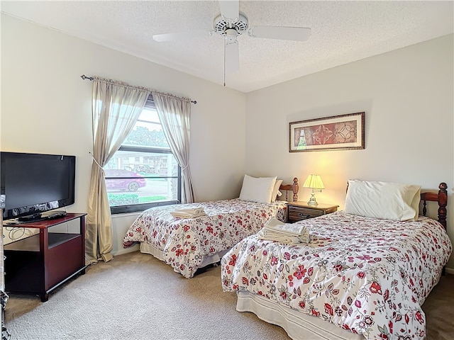 bedroom featuring a textured ceiling, carpet flooring, and ceiling fan