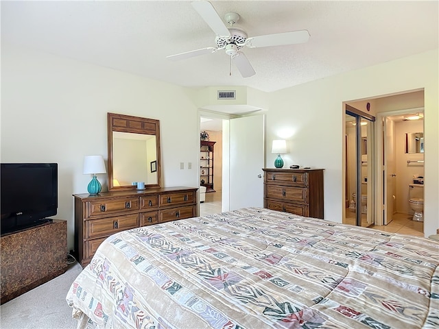 carpeted bedroom featuring a textured ceiling, ceiling fan, and ensuite bathroom