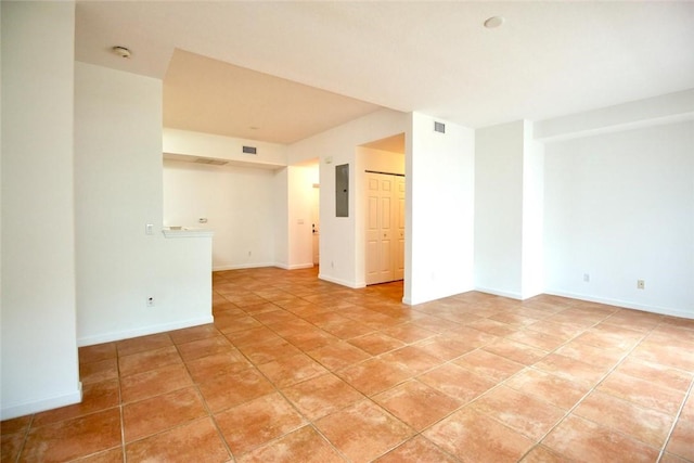 500 7th Pl Unit 102, Vero Beach, FL 32962 - empty room with electric panel, a smoke detector, light tile patterned floors, and baseboards
