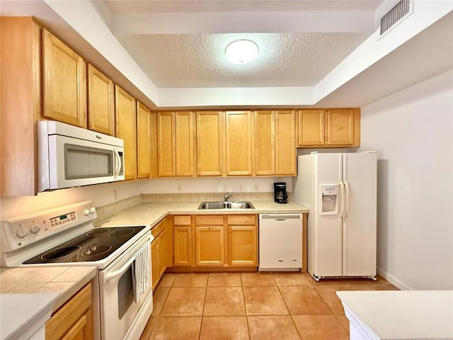500 7th Pl Unit 102, Vero Beach, FL 32962 - kitchen with white appliances, a sink, a textured ceiling, light tile patterned floors, and tile counters