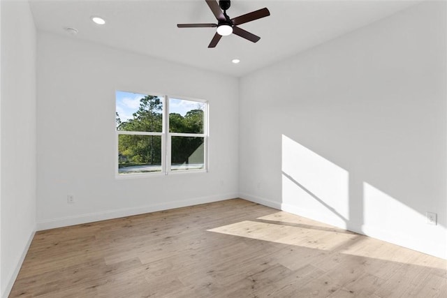 empty room with ceiling fan and light wood-type flooring