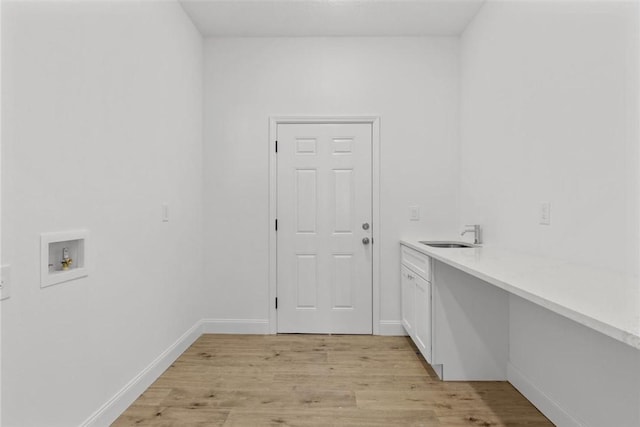 laundry room with cabinets, sink, washer hookup, and light hardwood / wood-style flooring