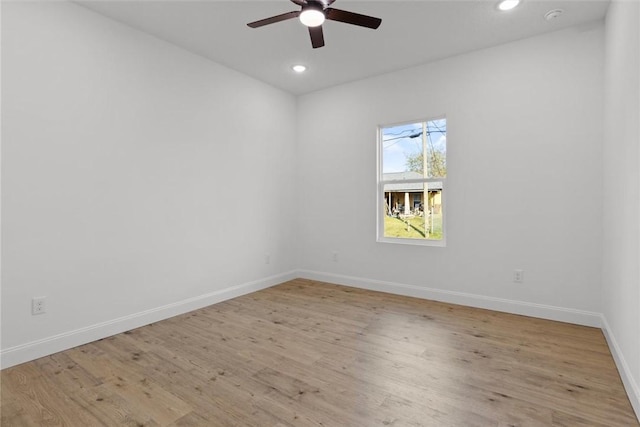 spare room featuring ceiling fan and light wood-type flooring