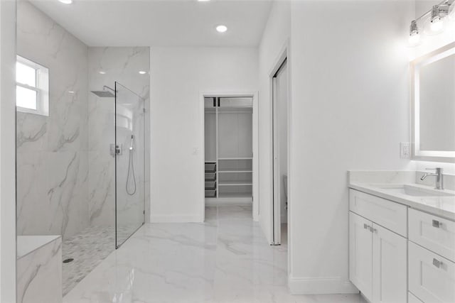 bathroom featuring vanity and tiled shower