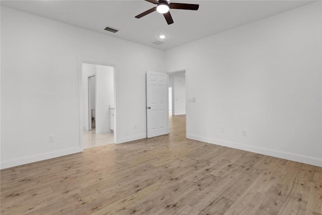 unfurnished bedroom featuring connected bathroom, light hardwood / wood-style floors, and ceiling fan