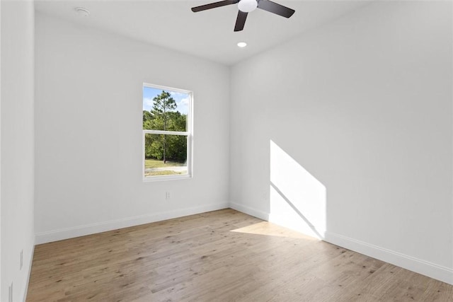 empty room with ceiling fan and light wood-type flooring