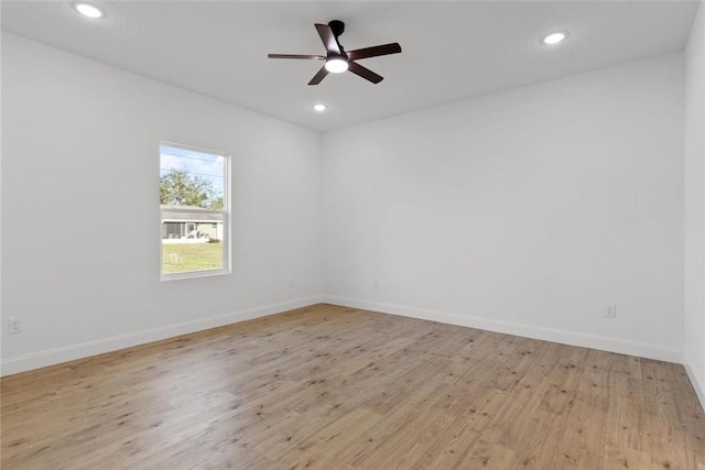 empty room with ceiling fan and light wood-type flooring