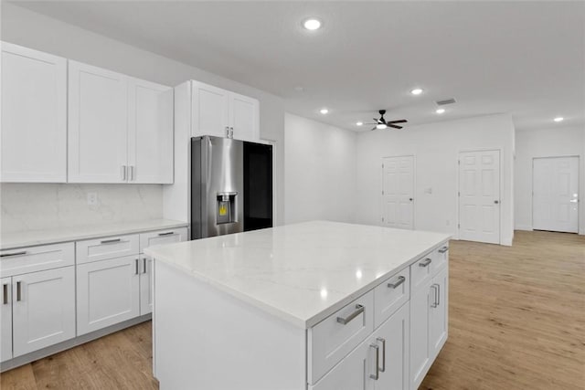 kitchen featuring white cabinetry, a center island, light wood-type flooring, and stainless steel fridge with ice dispenser