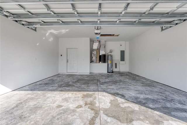 garage with a garage door opener, electric panel, and electric water heater