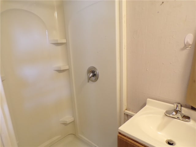 bathroom with vanity and walk in shower