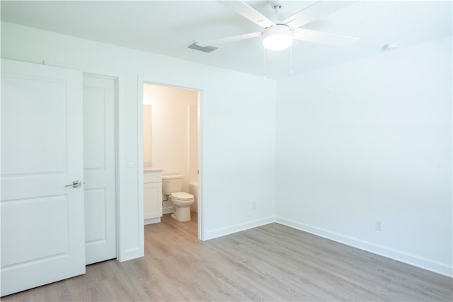 unfurnished bedroom with ensuite bathroom, light wood-type flooring, and ceiling fan