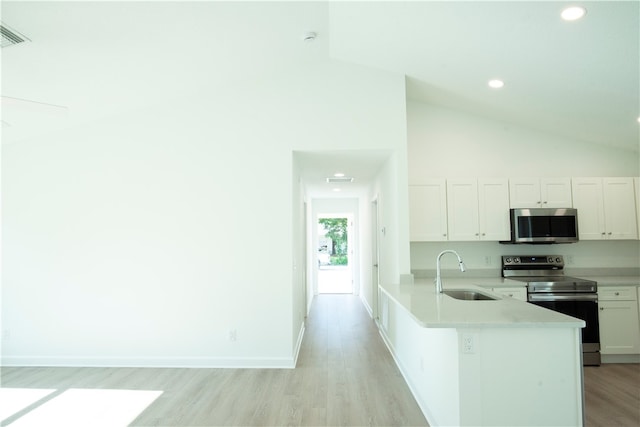 kitchen featuring stainless steel appliances, sink, high vaulted ceiling, white cabinetry, and light hardwood / wood-style flooring