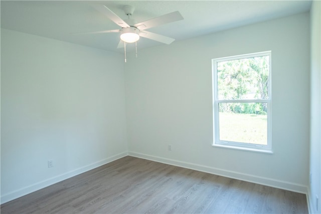 spare room featuring light wood-type flooring and ceiling fan