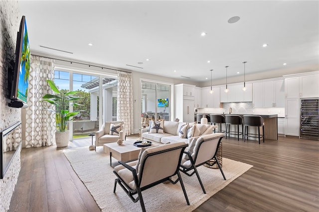 living room with a fireplace, wood finished floors, and recessed lighting