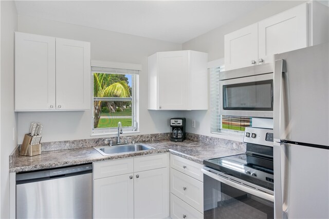 kitchen with white cabinets, sink, and appliances with stainless steel finishes